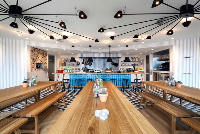 Modern event space in Zoku Amsterdam with communal dining for networking and team-building.