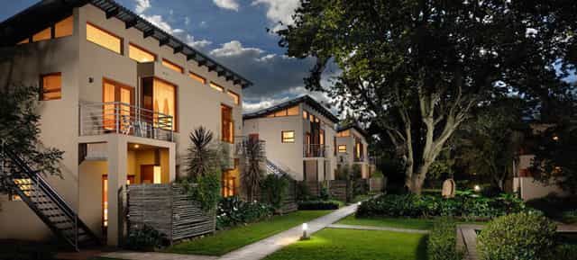 Boardroom at The Peech Hotel: modern outdoor venue with lush landscaping for events.