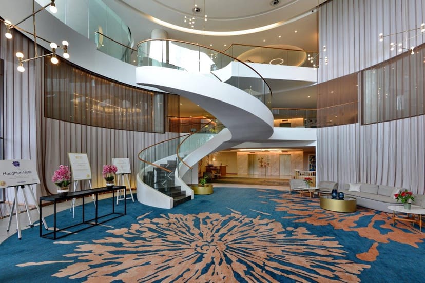 Modern conference center lobby with elegant spiral staircase, ideal for meetings and events.