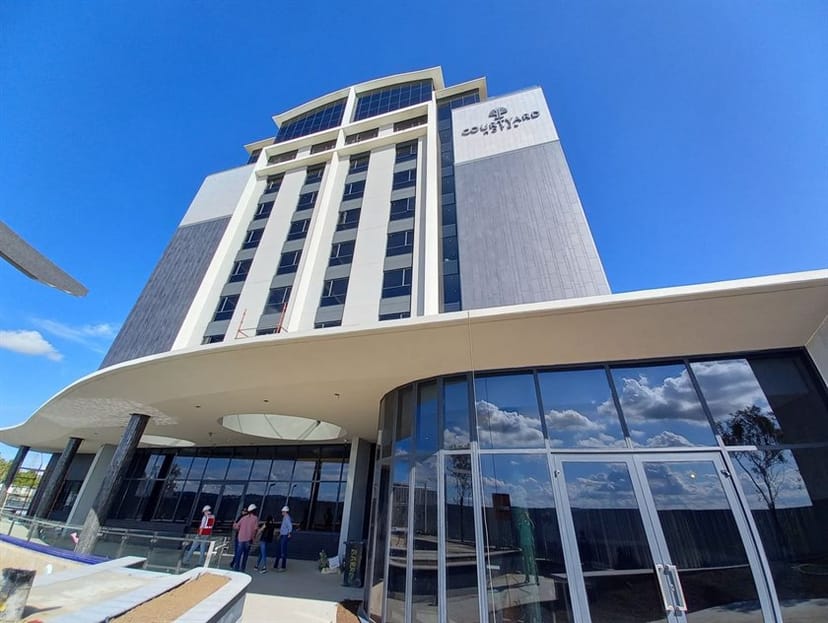 Modern Courtyard Hotel lounge with glass entrance, perfect for corporate events and gatherings.