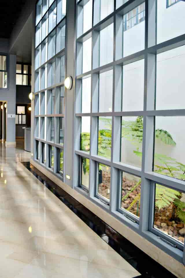 Modern Auditorium corridor with large windows, ideal for networking events and meetings.