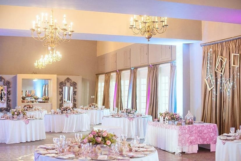 Elegant banquet conference setup at Indaba Hotel with floral arrangements for weddings.
