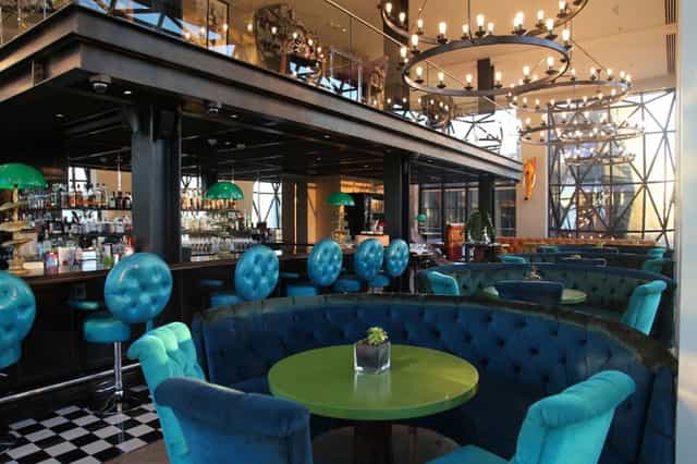 Stylish event space at The Willaston Bar, featuring turquoise seating for gatherings.
