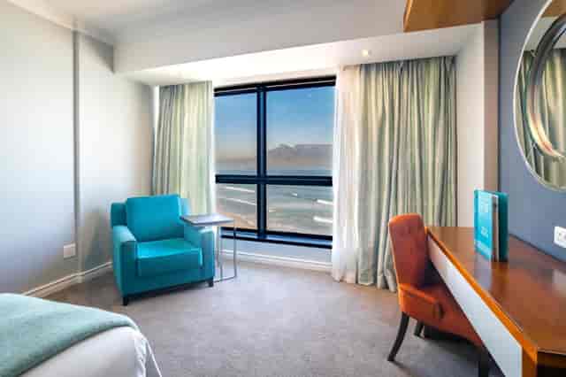 Cozy hotel room with natural light for meetings & retreats at Blaauwberg Beach Hotel.
