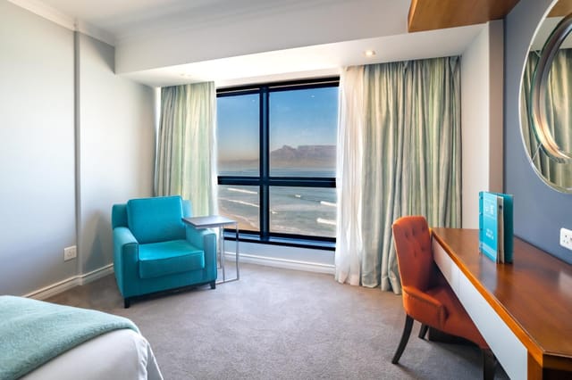 Cozy hotel room with natural light for meetings & retreats at Blaauwberg Beach Hotel.