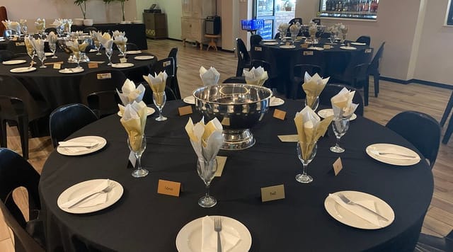 Elegant conference hall setup with round tables for formal events and dinners.