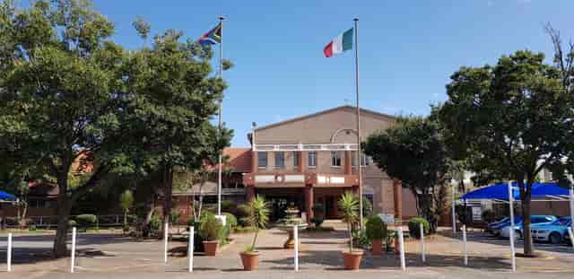 Crawford Italia venue entrance with flags, inviting for outdoor events in The Italian Club.