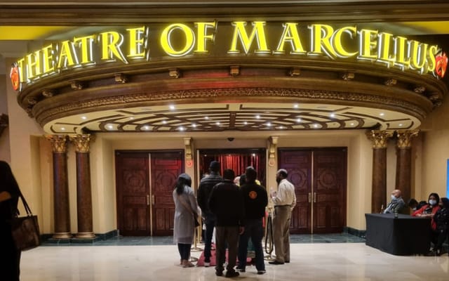 Theatre of Marcellus entrance with ornate signage, vibrant venue for large events.