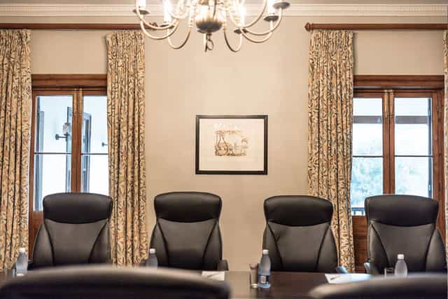 Brodie Suite conference room with leather chairs, ideal for professional meetings and events.