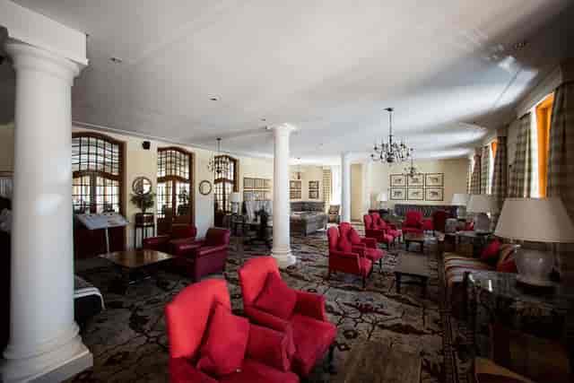 Grill Room at Kelvin Grove Club: elegant meeting space with plush red seating for events.