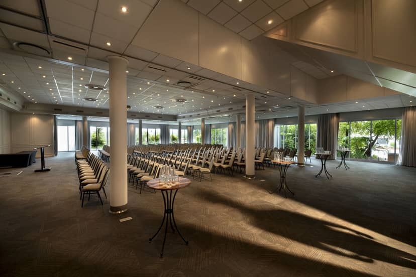 Elegant ballroom venue with natural light, ideal for conferences and corporate events.