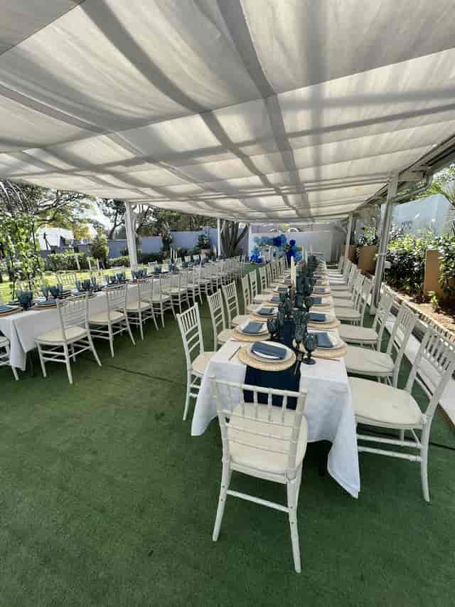 Elegant outdoor dining setup with navy accents, ideal for weddings or upscale events.