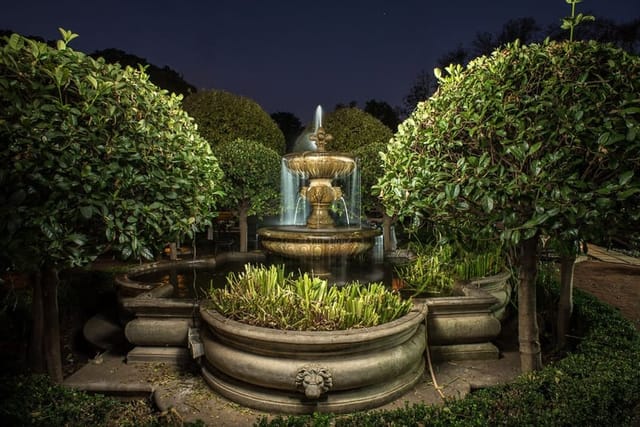 "Illuminated fountain in River Meadow Manor for elegant outdoor events and receptions."