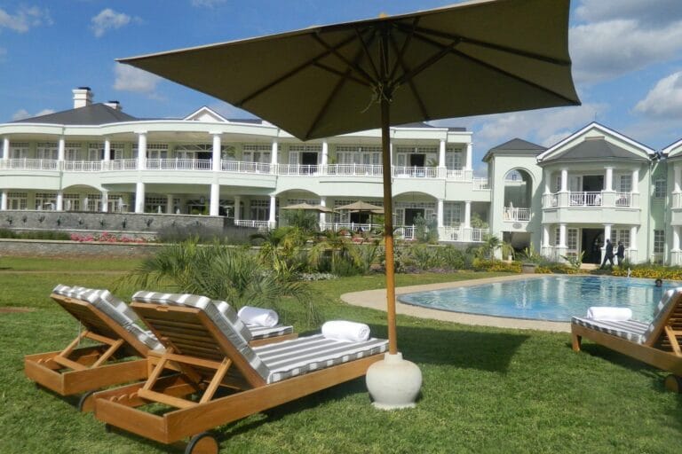 "Outdoor event venue at Hemingways Nairobi with elegant loungers and scenic lawn"