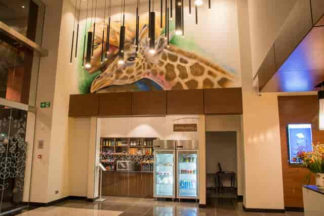 Garden Suite 1 lobby at Hilton Garden Inn Nairobi with a vibrant giraffe mural, perfect for events.