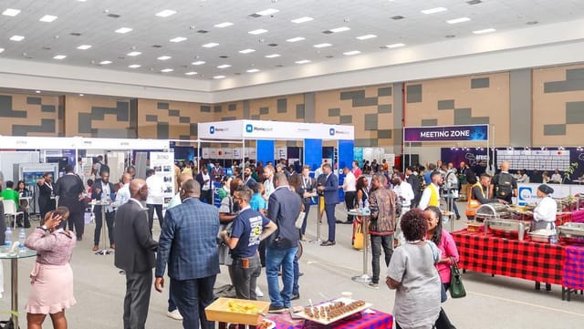 "Main Hall Sarit Expo Centre with attendees networking at vibrant conference booths"