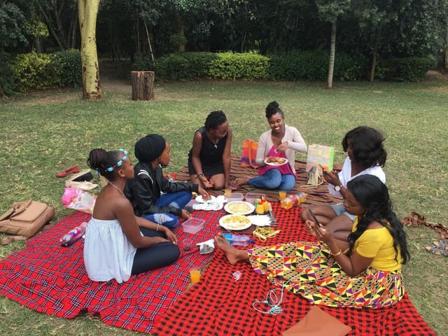 Outdoor team-building event at Langata Botanical Gardens with vibrant picnic setup.