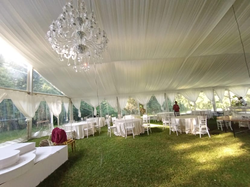 Outdoor marquee event at Langata Botanical Gardens with elegant white seating.
