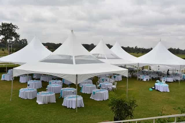 Elegant white tent setup for sophisticated outdoor wedding or corporate event.