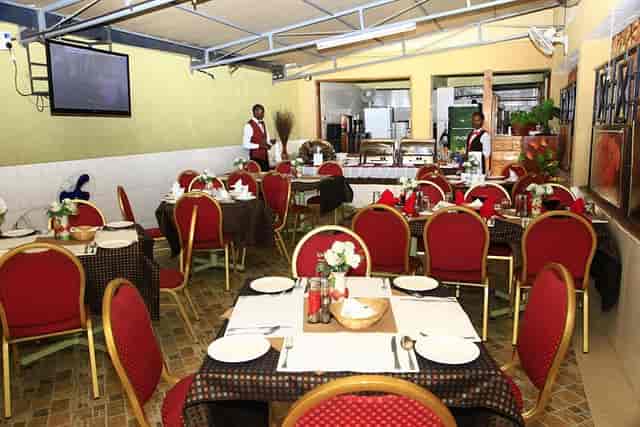 Elegant dining area in restaurant for expat events, featuring floral centerpieces and warm decor.