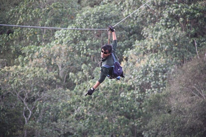 Participant zip-lining at The Flying Elephant, perfect for corporate team-building events.