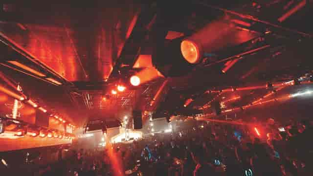 Vibrant MUZE bar with energetic crowd and dynamic lighting for nightlife events.
