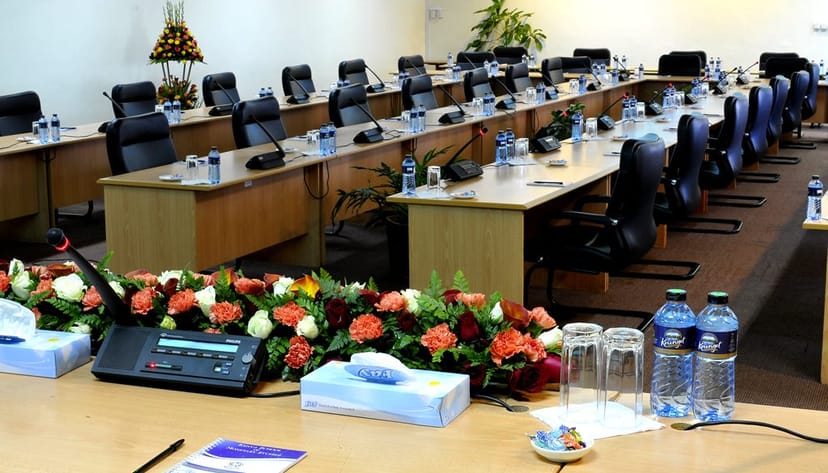 Conference room with elegant floral centerpiece for meetings and events at KSMS Centre.