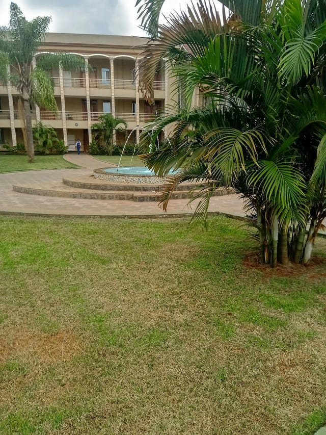 Outdoor conference center in KSMS with fountain and landscaped greenery for events.