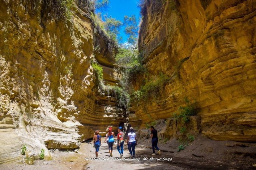 Group in sunlit canyon at Hell's Gate National Park for team-building retreat.