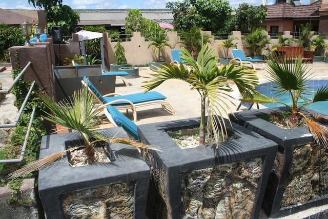 Outdoor restaurant event space with pool, loungers, and lush greenery at Galaxy Resort Kitengela.