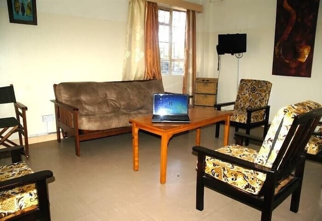 Cozy Shalom House conference room with laptop, ideal for meetings and workshops.
