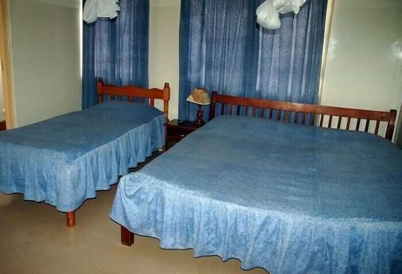 Conference Room at Shalom House with blue bedspreads, ideal for budget-friendly events.