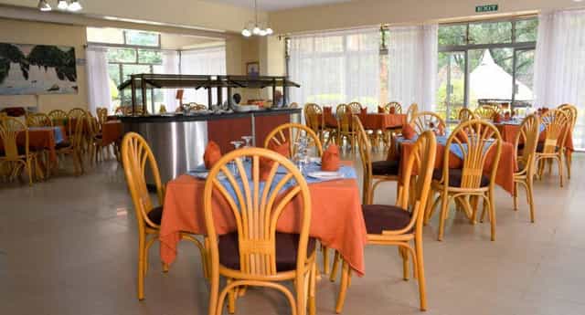 Spacious restaurant dining area in Golf Hotel Kakamega, perfect for meetings and events.
