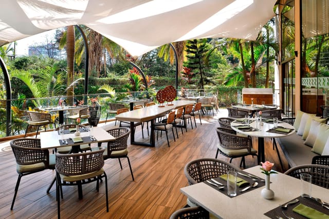 Kenyatta University dining space with lush greenery, ideal for meetings and events.