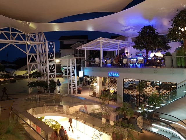 Stylish outdoor Atrium venue with soft lighting, perfect for evening events and gatherings.