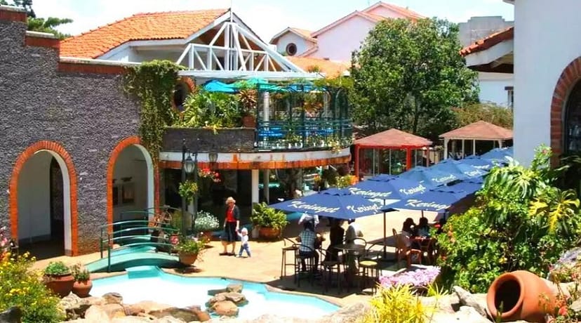 Vibrant outdoor venue at Village Market Atrium with lush greenery for events and meetings.