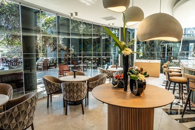 Modern event venue in Saxon Hotel with elegant decor & natural light for meetings.