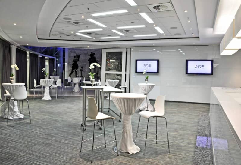 Modern Atrium event space with high-top tables for corporate networking and receptions.