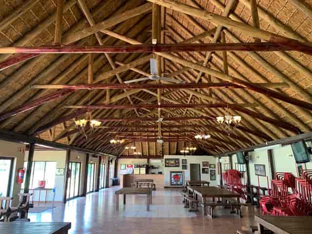 Wedding venue at The Wanderers Club with high thatched roof and rustic decor.