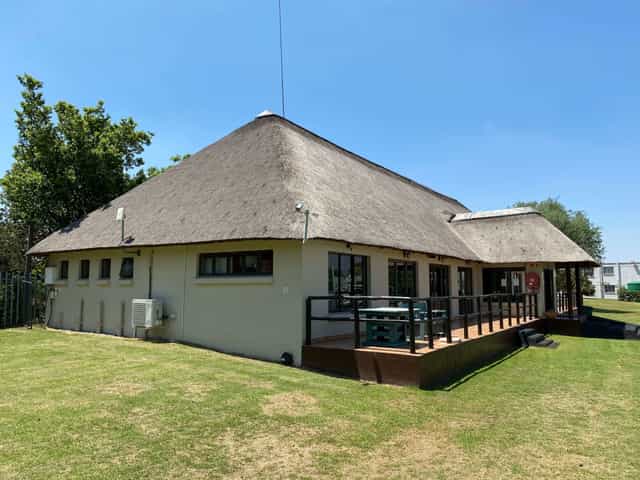 Wedding venue at The Wanderers Club with a thatched roof, ideal for outdoor events.