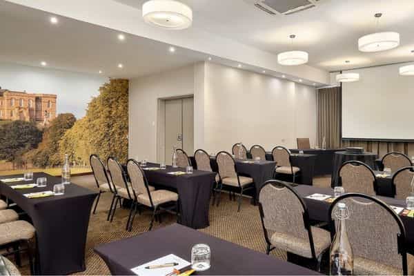 Conference room with elegant tables for professional workshops and presentations.