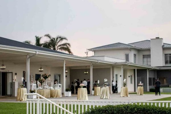 Elegant Mudd Hut venue with gold tablecloths, perfect for outdoor meetings or receptions.