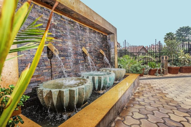 Outdoor deck at The Monarch Hotel with a decorative fountain, perfect for networking events.