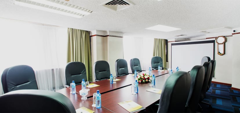 Conference room in The Nairobi Club with a long table, ideal for meetings and events.