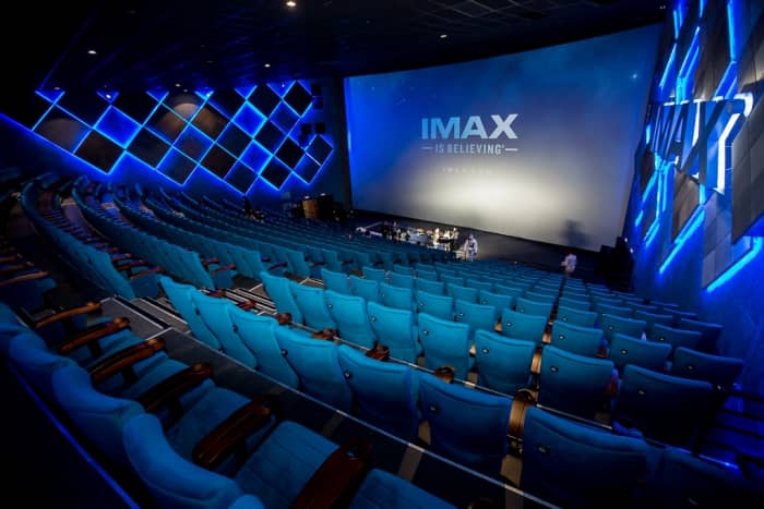 Spacious IMAX theater with blue seating for immersive multimedia events.