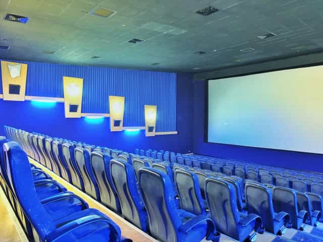Modern movie theater auditorium with tiered seating for events and screenings.