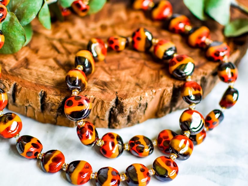 Handcrafted vibrant necklace with warm beads for event decor and gifting inspiration.