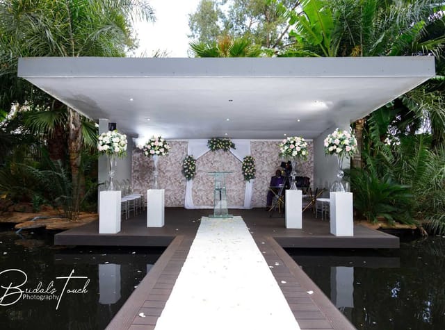Outdoor wedding venue with floral decor and serene garden setting at The Forum.