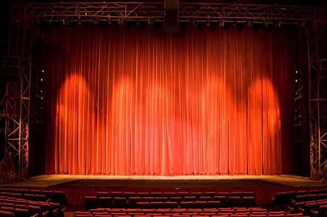 Spacious Joburg Theatre stage with red curtains, perfect for performances and presentations.