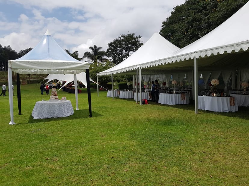 Elegant outdoor event setup at Lower Grounds, featuring white tents and table linens.